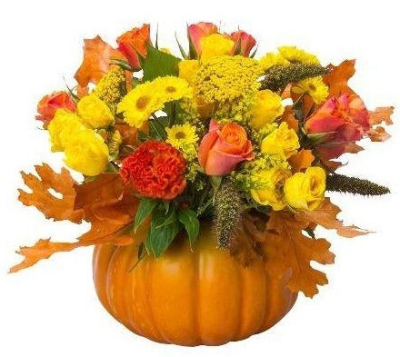 Orange and Yellow Flowers in a Pumpkin